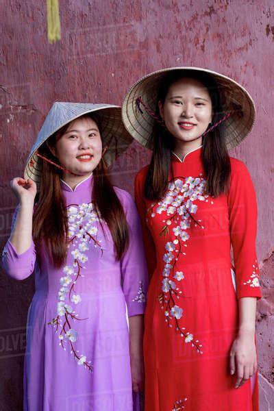 Young Vietnamese Women Wearing A Traditional Ao Dai Dress Vietnam Indochina Southeast Asia