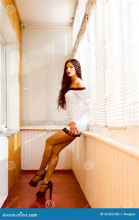 Seductive Beautiful Brunette Pinup Girl In White Dress Touching Sensually Her Hips And Dreaming