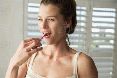 Babe Woman Brushing Teeth In Bathroom Stock Photo Dissolve