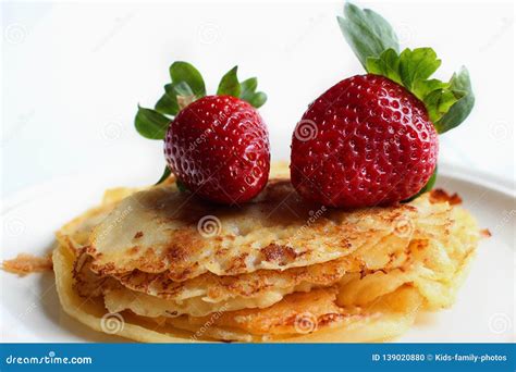 Pile Of Pancakes With Juicy Strawberries On White Plate Stock Photo