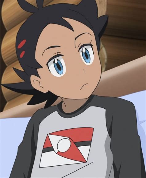 An Anime Character With Black Hair And Blue Eyes Wearing A Gray T