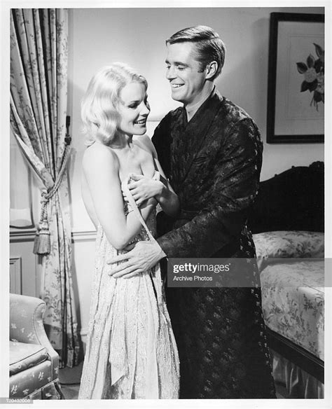 Carroll Baker Is Held By George Peppard In A Scene From The Film The