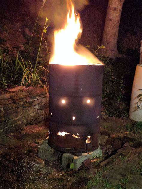 Burning wood in a worn burn barrel that looks a little angry! | Burn