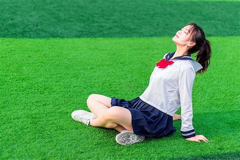 Beautiful Japanese Girl Sitting On The Lawn In The Afternoon