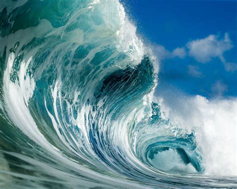 An Ocean Wave Is Breaking Into The Blue Sky