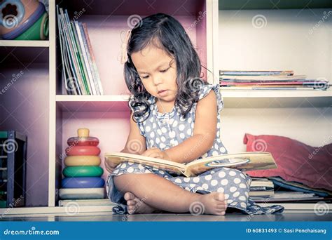 Child Read Cute Little Girl Reading A Book And Sitting On Floor Stock