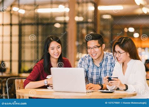 Asian College Students Group Or Coworkers Using Laptop Computer