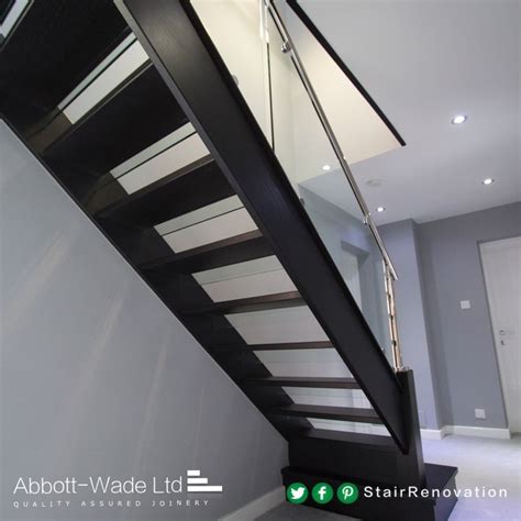 An Open Tread Black Oak Staircase With Steel Rail And Glass Balustrade