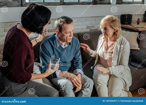 wife and therapist sitting around shocked husband stock image image of couple explaining
