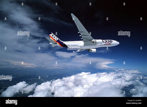 Passenger Aircraft In Flight Airbus A330 Flying Above Cloud Stock Photo