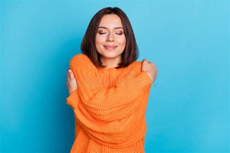 Portrait Of Attractive Dreamy Cheerful Girl Hugging Herself Isolated Over Bright Blue Color