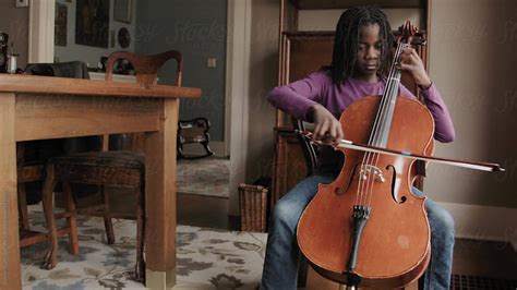 black girl practicing cello at home by stocksy contributor gabi bucataru stocksy