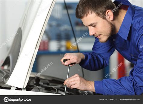 Mechanic Repairing A Car In A Workshop — Stock Photo © Antonioguillemf