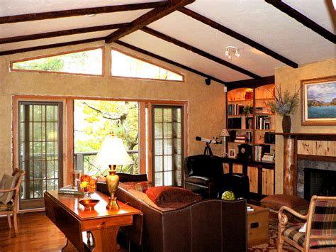 The beams give the illusion that they are running from the kitchen to the outdoor room making them look like they are supporting the structure of the house. Timber Faux Beam Ceiling Design - Family Room - New York ...