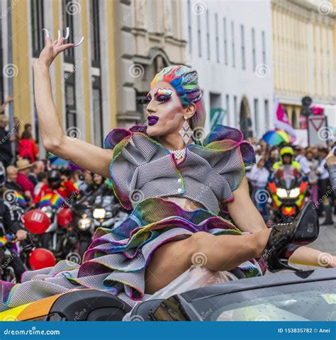 A Drag Queen On A Car Waving To The Crowds At The Gay Pride Parade Also
