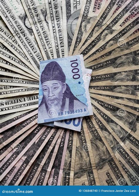 South Korean Banknote of 1000 Won and Background with American Dollars