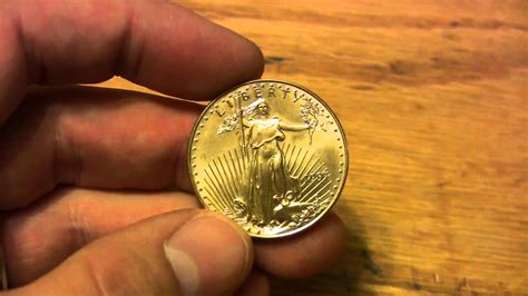How much does 1oz of gold weigh in grams? Gold Bullion - Detail of 1 ounce Gold Eagle coin - YouTube