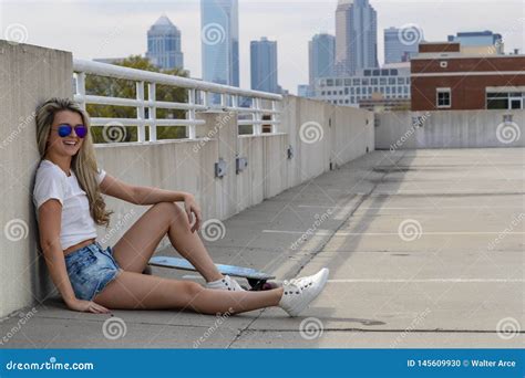 Gorgeous Young Coed Model Enjoying The Warm Weather With Her Skateboard