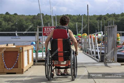 Woman With A Spinal Cord Injury In A Wheelchair On A Boat Dock