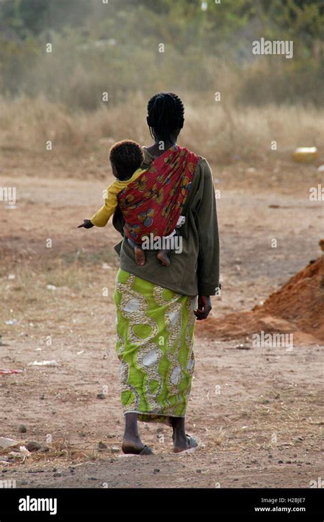 African Woman Carrying Baby On Back Stock Photo Alamy