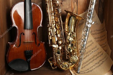 Musical Instruments Saxophone Violin And Flute With Notes On Wooden
