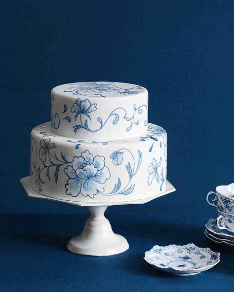 Blue cake on three floors with gold ornaments on it isolated on white background. Blue and Purple Wedding Cakes | Martha Stewart Weddings