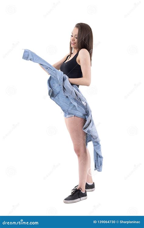 Relaxed Young Beautiful Brunette Woman Taking Off Jeans Jacket Stock