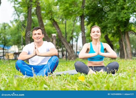 Young Couple Doing Yoga In Park Together Stock Photo Image Of Nature