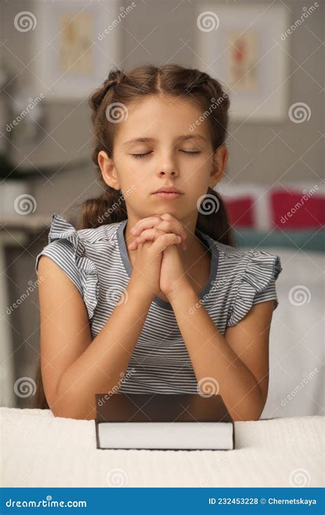 Cute Little Girl Praying Over Bible In Bedroom Stock Photo Image Of
