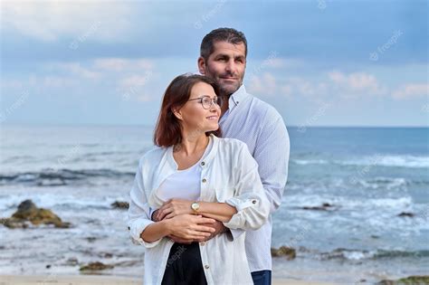 Premium Photo Outdoor Portrait Of Mature Couple Hugging On The Seashore