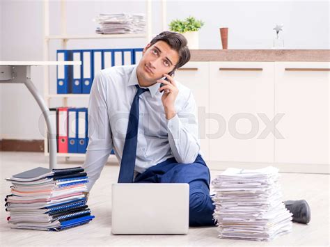 Extremely Busy Employee Working In The Office Stock Image Colourbox