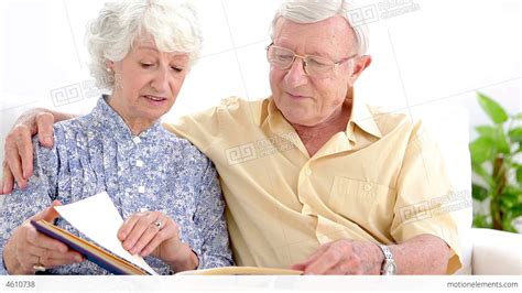old couple looking at photo album stock video footage 4610738