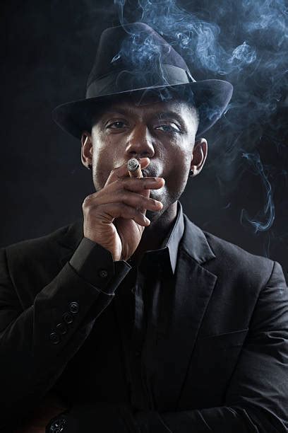 Best Black American Mafia Gangster Man In Suit Smoking Cigar Stock