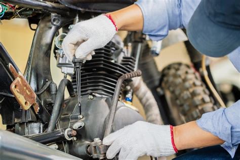 Premium Photo Man Repairing Motorcycle In Repair Shop Mechanic Fixing