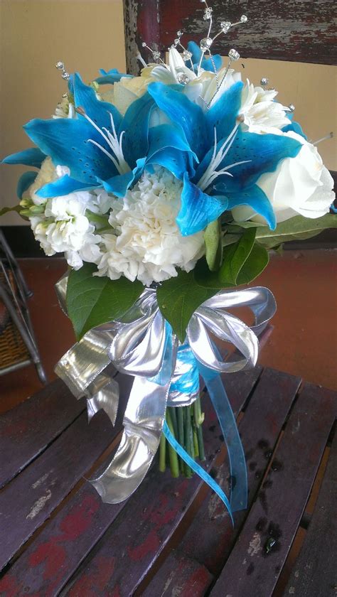 Wedding bouquet of white roses with string of pearls necklace and heart sign against purple lilac background. Blue and White Wedding Bouquet...Blue, Silver, White ...