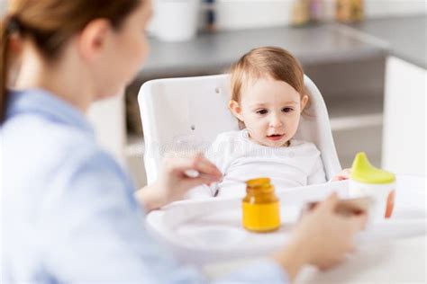 Happy Mother Feeding Baby With Puree At Home Stock Photo Image Of