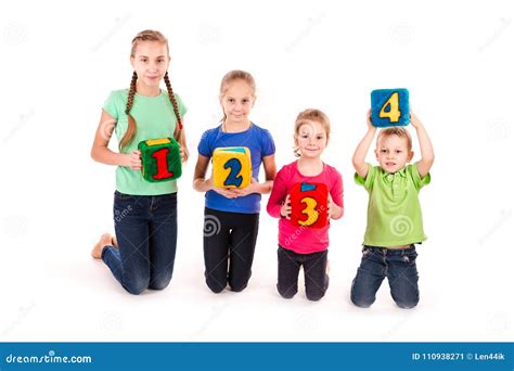 Happy Kids Holding Blocks With Numbers Over White Background Stock