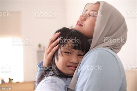 Asian Muslim Mother Hijab Calming Her Sad And Crying Daughter Single