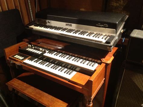 An Organ Sits In Front Of Other Musical Equipment