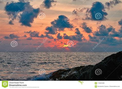 Seascape Summer Sunset At Sea With Rocks Clouds Over Sea In Orange
