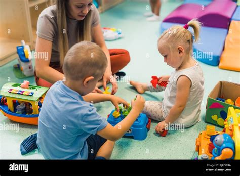 Learning through sensory play at the nursery school. Caucasian toddlers