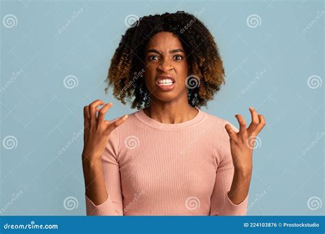 Portrait Of Angry African American Woman Looking At Camera With Rage