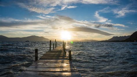 Wooden Dock On A Lake At Sunset With Mountains Stock Image Image Of