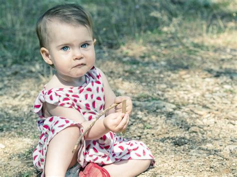 Baby Girl Is Sitting On The Ground Stock Image Image Of Landscape