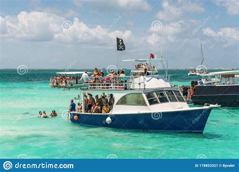 tourists and boats at wild stingray city on gran cayman cayman islands editorial photo image