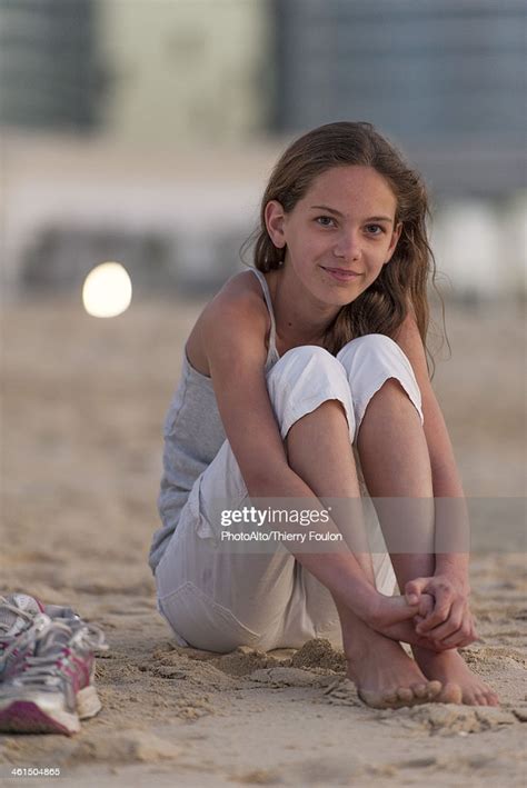 Preteen Girl Sitting On Beach With Barefeet Hugging Knees Photo Getty