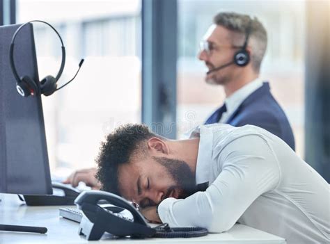 Lazy Sleeping And Tired Call Center Agent At His Table Or Desk At Work