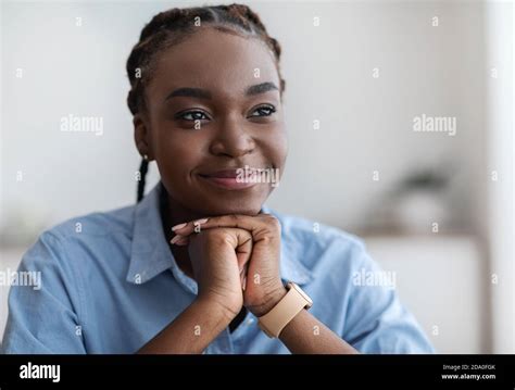 Closeup Portrait Of Dreamy Young Black Woman With Braids Looking Away