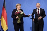 Angela Merkel greets successor Olaf Scholz after 16 years as German leader