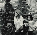 Actress Jane Fonda sitting on a North Vietnamese anti-aircraft gun ...